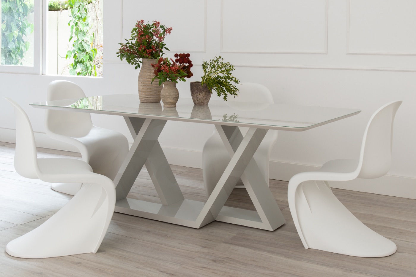 Dining table with sculptural base in a bright showroom